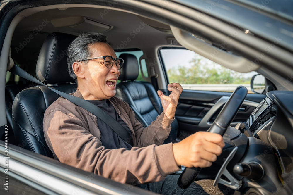 Senior asian man has broken down car on the road he feeling serious and stressed. Look for someone help. Mature Driving during rush hour But the traffic is very congested. Shocked face Senior asian man has broken down car on the road he feeling serious and stressed. Look for someone help. Mature Driving during rush hour But the traffic is very congested. Shocked face