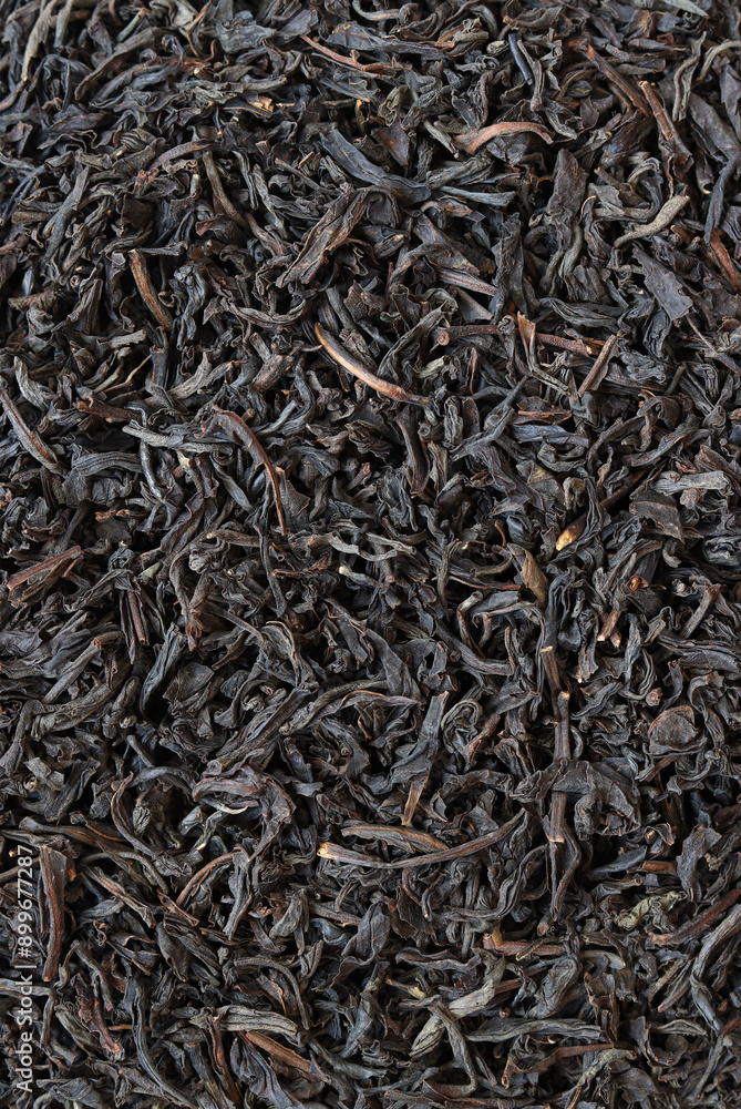 Long black tea, texture. Top view of dried tea leaves. Tea composition. Ingredients for a hot drink, close-up. Background Long black tea, texture. Top view of dried tea leaves. Tea composition. Ingredients for a hot drink, close-up. Background