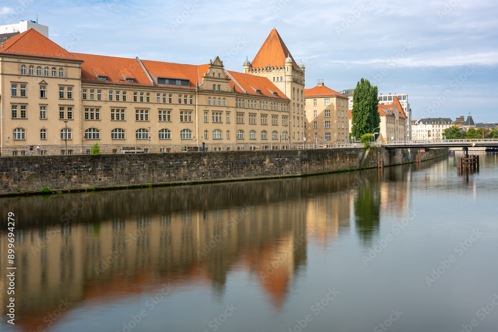 Fototapeta premium Buildings of Berlin standing near the river are reflected in the water. Embankment of Berlin.