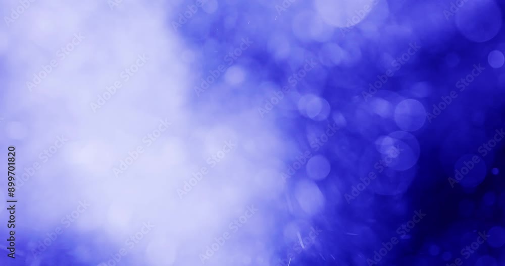 Bokeh And Glittering Particles Against Blue Background Bokeh And Glittering Particles Against Blue Background