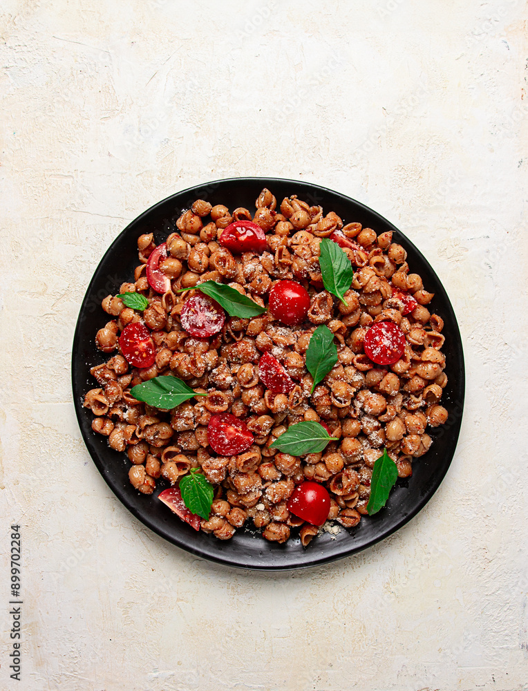 Tuscan pasta with smoked paprika and basil,parmesan cheese, Italian traditional cuisine, Tuscan pasta with smoked paprika and basil,parmesan cheese, Italian traditional cuisine,