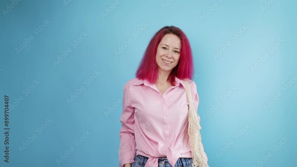 Net bag, Woman with pink hair reusable mesh on blue background, contributing to a plastic-free environment Net bag, Woman with pink hair reusable mesh on blue background, contributing to a plastic-free environment
