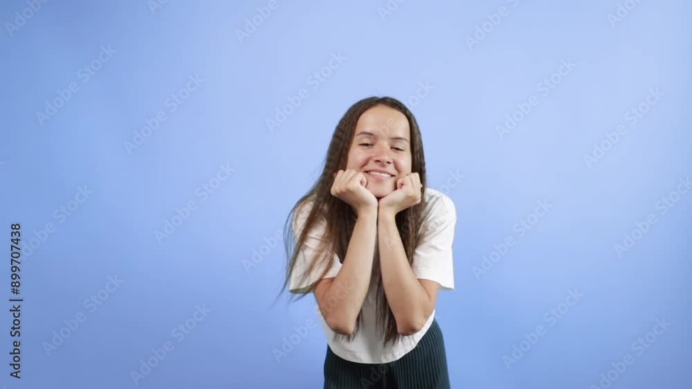 Teenager portrait on blue background, young cute emotional student, cheerful smile on pretty face of female. Teenager portrait on blue background, young cute emotional student, cheerful smile on pretty face of female.