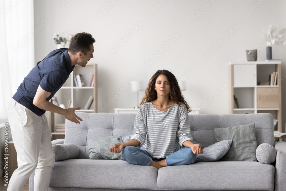 Husband accusing screams on wife while she meditating escaping from marriage and relationships problems, keep emotional balance, coping with stress. Communication breakdown, misunderstanding, jealousy