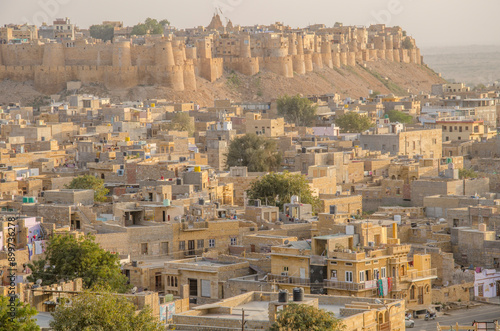 Jaisalmer, the Golden City, view with yellow stone buildings and ancient fortress on the background, in the heart of the Thar Desert, Rajasthan India, Asia. photo