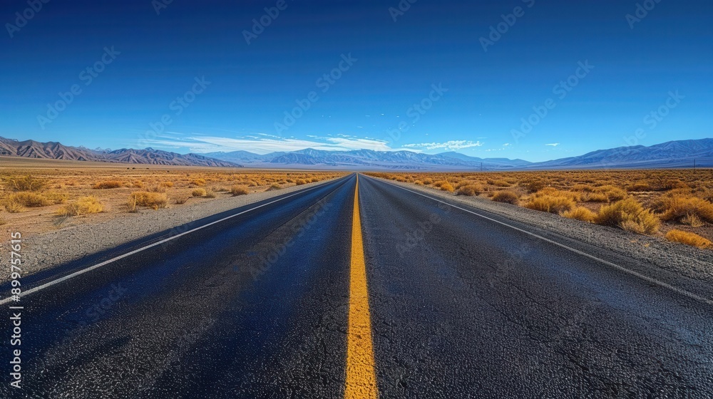 A solitary asphalt road stretches into the horizon A solitary asphalt road stretches into the horizon