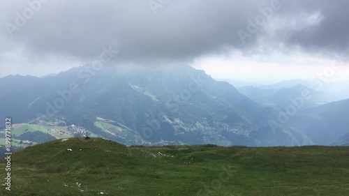 Hiking on Mount Arera , in the Italian Alps, during a Cloudy Summer Day. Zambla Alta, Bergamo Province, Italy photo