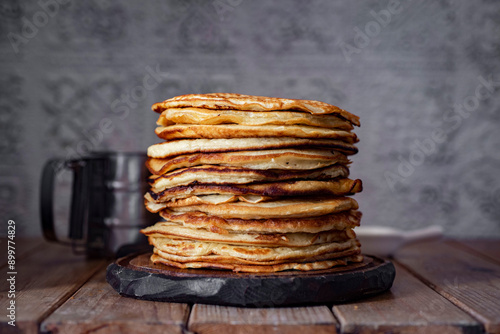 Wallpaper Mural A stack of pancakes on a wooden table on a gray background. Thin pancakes for breakfast for the whole family. Close-up. Torontodigital.ca