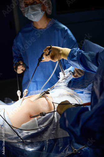 Close up of team of surgeons operating in operating room endoscopy while using modern technology