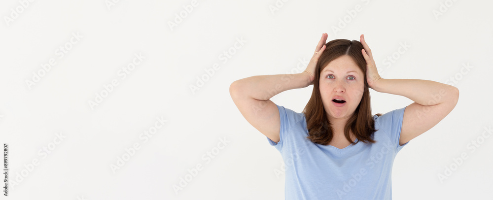 Photo of shocked afraid cute girl open mouth hands head wear blue t-shirt isolated white background Photo of shocked afraid cute girl open mouth hands head wear blue t-shirt isolated white background