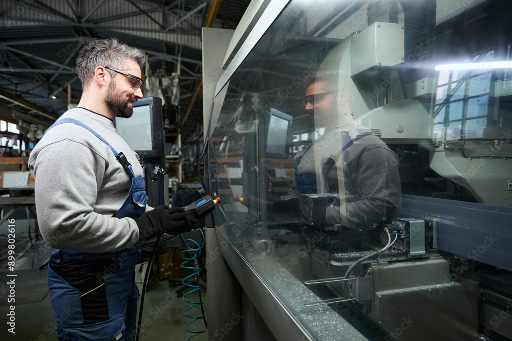Professional uses a control panel to work on modern equipment Professional uses a control panel to work on modern equipment