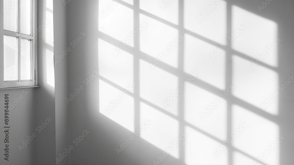 Sunlight casting geometric patterns through window on white wall, casting shadows concept Sunlight casting geometric patterns through window on white wall, casting shadows concept