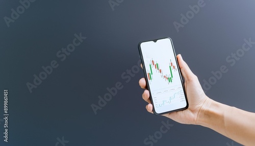 Finger pointing to smartphone for stock trading