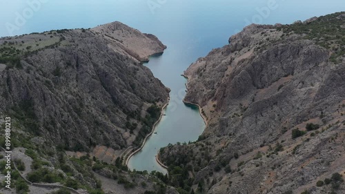Zavratnica in Croatia. It is a 900 m long narrow inlet located at the foot of the mighty Velebit Mountains, in the northern part of the Adriatic Sea, 1 km south of Jablanac, Croatia. Drone, 4k.