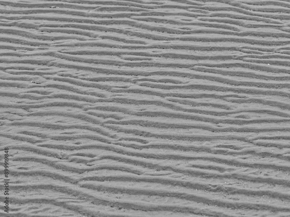 Sand structures in the mudflats in the North Sea, minimal black and white photo Sand structures in the mudflats in the North Sea, minimal black and white photo