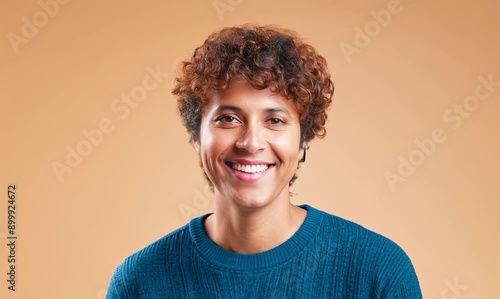 Cheerful adult wearing casual clothing smiles confidently in front view portrait on colored background