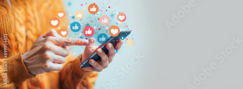 Social media and digital online communication concept, man using smartphone with likes icons on social media. Banner background.