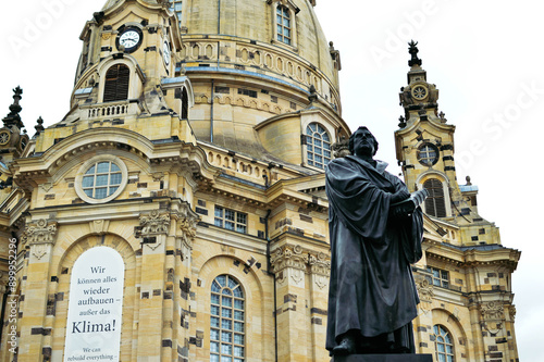 Martin Luther monument in front of the Frauenkirche in the center of Dresden in summer in cloudy weather photo