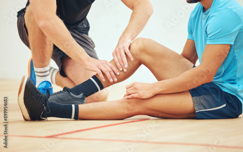 Injury, help and people in court, game and accident for playing in sports, training and practice. Suffering, sportsman and confident of tournament, squash player and exercise of team and athlete