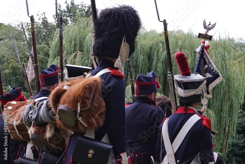 Marching soldiers dressed in the uniforms of the Duchy of Warsaw from the time of the Napoleonic Wars. photo