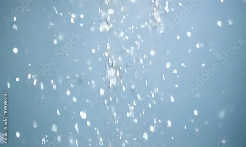 AI Generated video of aShiny confetti falling in slow motion, blue gray background