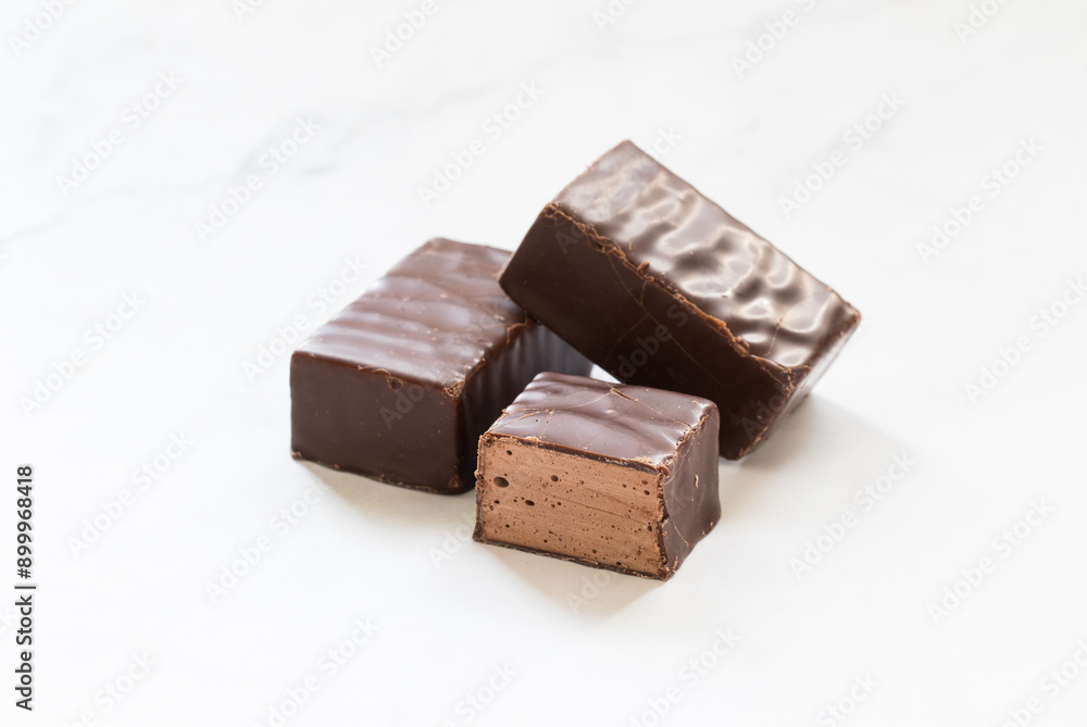 Vegan Chocolate bird's milk. Chocolate souffle in chocolate glaze. White background. Close-up Vegan Chocolate bird's milk. Chocolate souffle in chocolate glaze. White background. Close-up