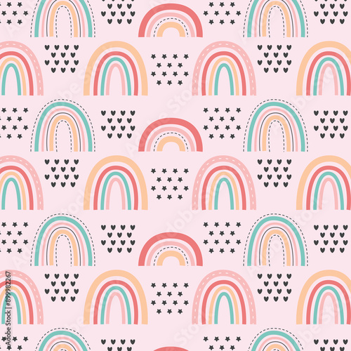 Childish seamless pattern with hand drawn rainbow, hearts and dots. Trendy kids vector background. © amna