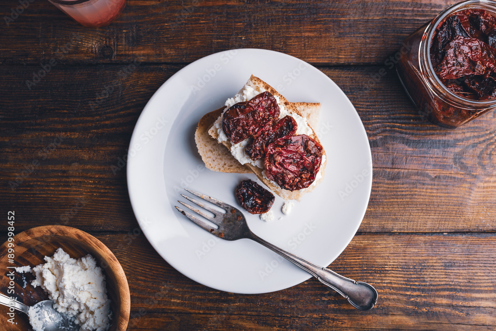 Sundried tomatoes and cream cheese on slice of bread Sundried tomatoes and cream cheese on slice of bread