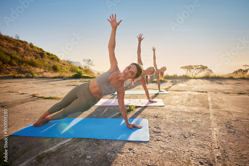 Group, women and stretching for yoga outdoor on mat for fitness training, body balance and muscle development. People, pilates and exercise for flexible, coaching class and workout performance of zen photo