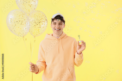 Young man with balloons and...