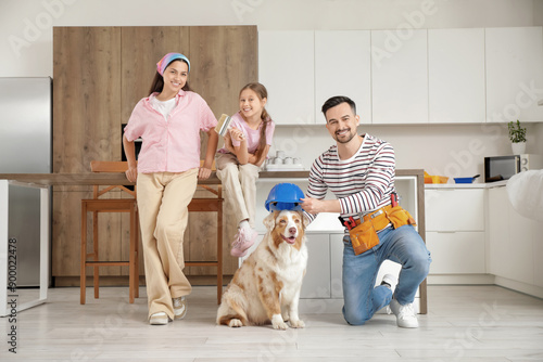 Happy family with dog durin...