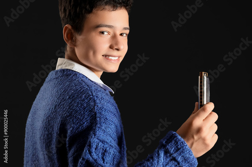 Teenage boy with harmonica ...
