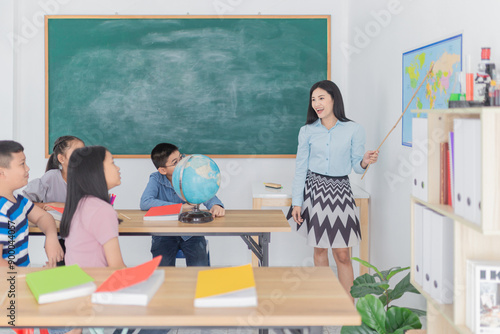 asian children students group learning about world map and history with female teacher, they feeling fun and happy in classroom, happiness elementary school
