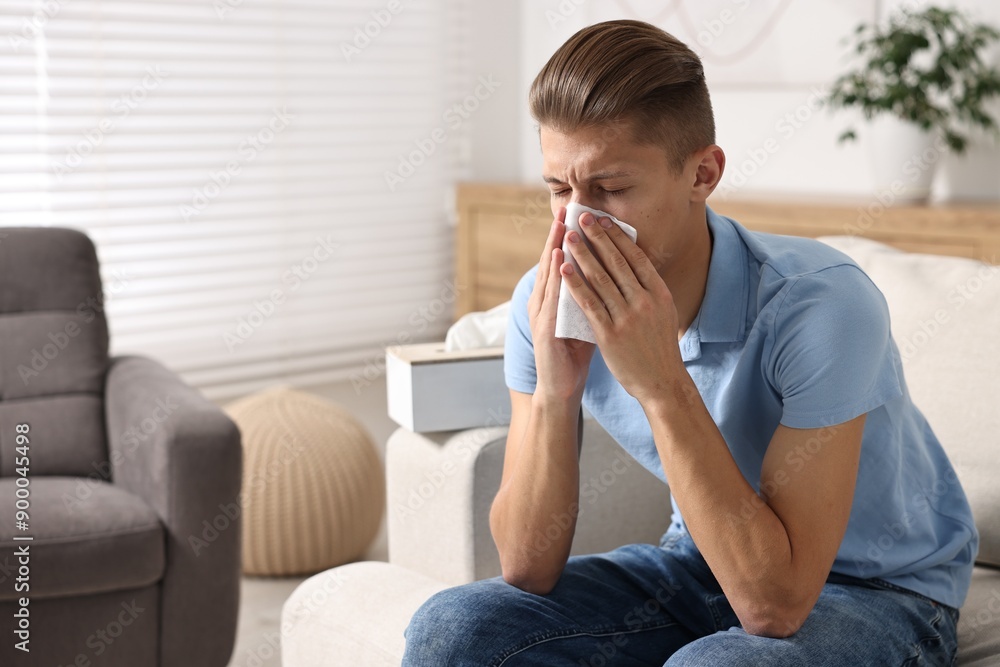Young man with tissue suffering from sinusitis at home Young man with tissue suffering from sinusitis at home