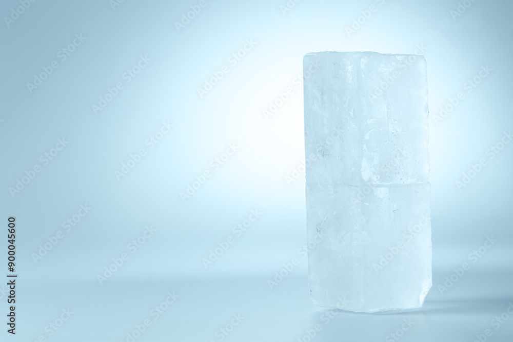 Blocks of clear ice on light blue background, space for text Blocks of clear ice on light blue background, space for text