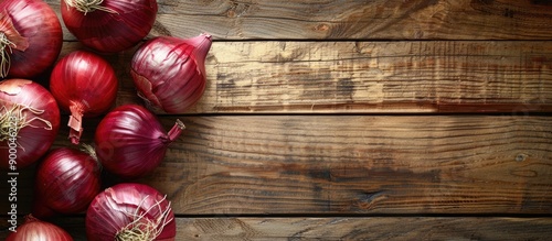 Red Onions on a bright wood...