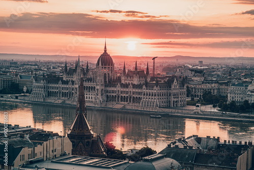 The Hungarian Parliament on the Danube River at dramatic Sunrise in Budapest photo