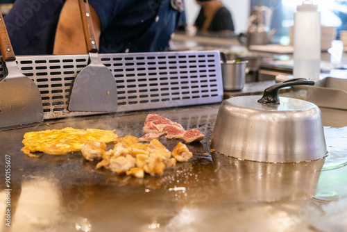 The chef is stirring the delicious Teppanyaki chicken and the aroma is overwhelming photo