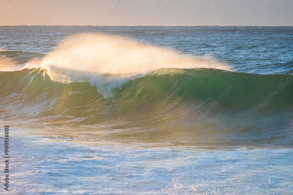 Fototapeta premium Close-up view of wave breaking with water spray.