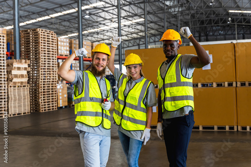 Group of diversity warehouse men and woman workers raising hands cheerful in distribution warehouse photo