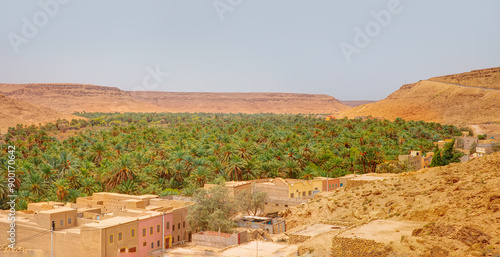 Old kasbah in Tinerhir, typical Moroccan town beside an oasis in Dades Valley - Ancient Berber village, lush green oasis in valley surrounded by the Atlas - Mountains - Tinghir, Morocco photo