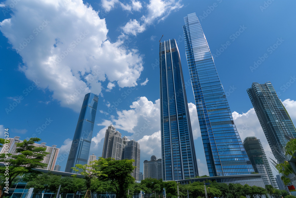 Skyscrapers Reaching into a Bright Blue Sky with White Clouds on a Sunny Day Skyscrapers Reaching into a Bright Blue Sky with White Clouds on a Sunny Day