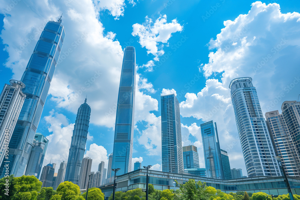 Skyscrapers Reaching into a Bright Blue Sky with White Clouds on a Sunny Day Skyscrapers Reaching into a Bright Blue Sky with White Clouds on a Sunny Day