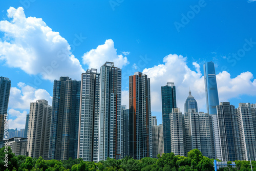 Skyscrapers Reaching into a Bright Blue Sky with White Clouds on a Sunny Day