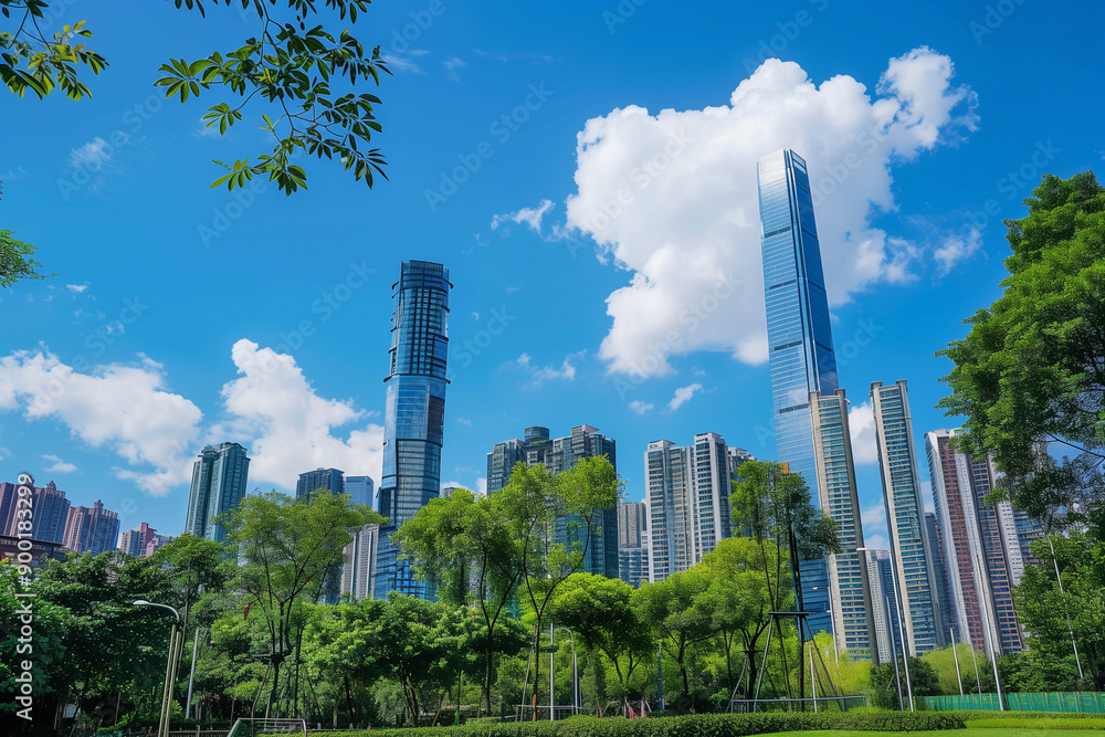 Fototapeta premium Skyscrapers Reaching into a Bright Blue Sky with White Clouds on a Sunny Day
