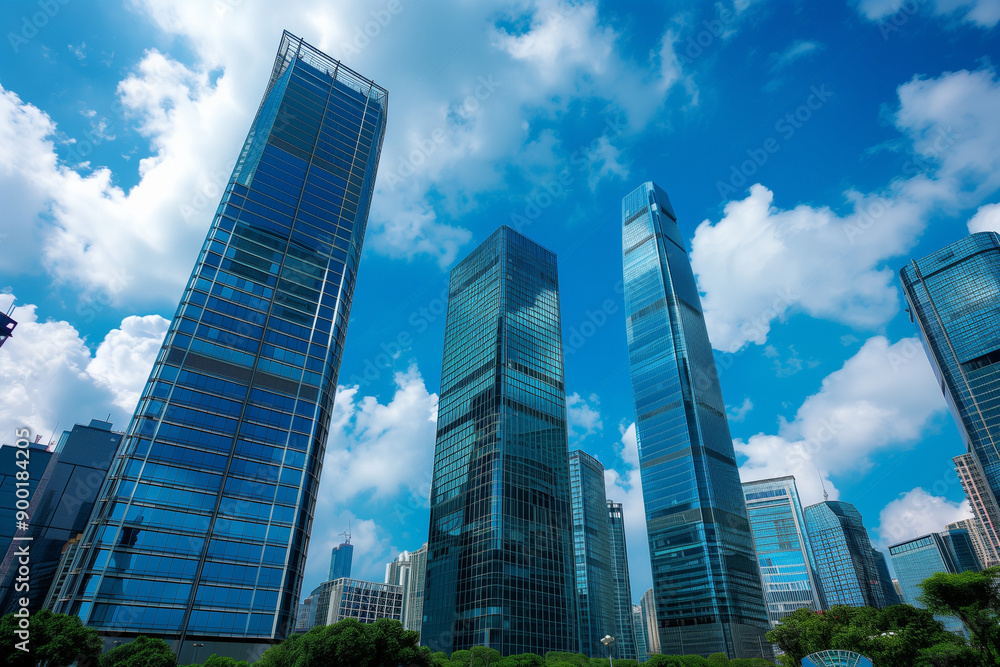 Skyscrapers Reaching into a Bright Blue Sky with White Clouds on a Sunny Day Skyscrapers Reaching into a Bright Blue Sky with White Clouds on a Sunny Day