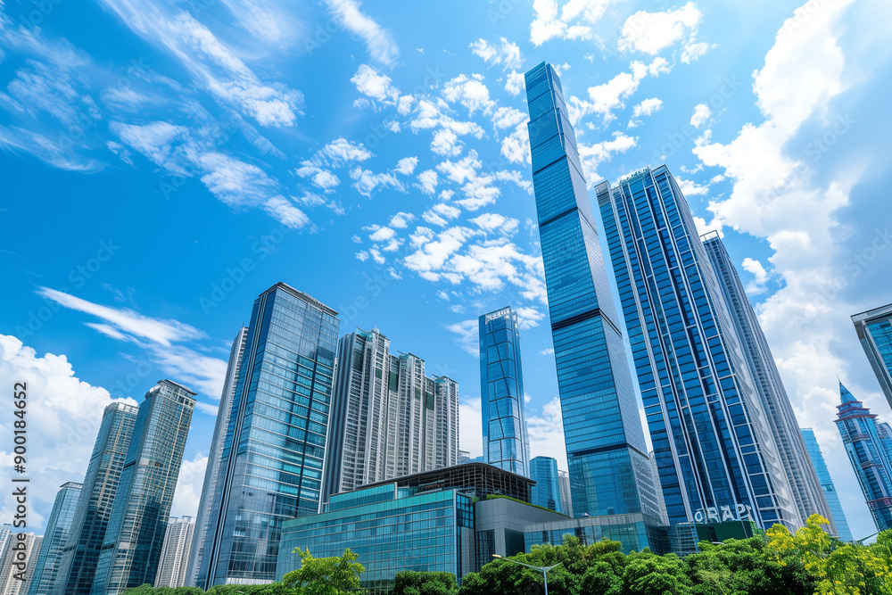 Skyscrapers Reaching into a Bright Blue Sky with White Clouds on a Sunny Day Skyscrapers Reaching into a Bright Blue Sky with White Clouds on a Sunny Day