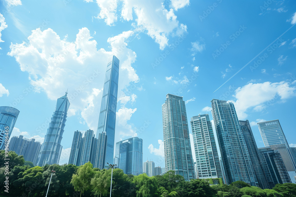 Skyscrapers Reaching into a Bright Blue Sky with White Clouds on a Sunny Day Skyscrapers Reaching into a Bright Blue Sky with White Clouds on a Sunny Day
