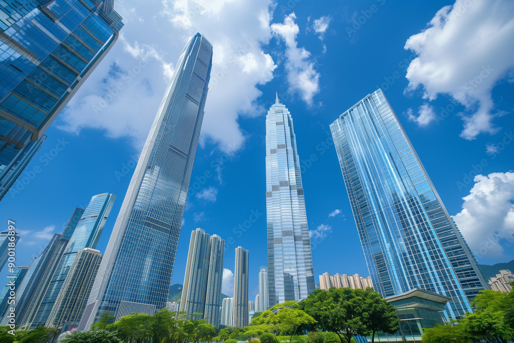 Skyscrapers Reaching into a Bright Blue Sky with White Clouds on a Sunny Day Skyscrapers Reaching into a Bright Blue Sky with White Clouds on a Sunny Day