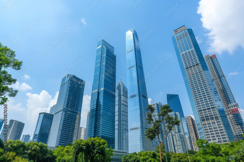 Skyscrapers Reaching into a Bright Blue Sky with White Clouds on a Sunny Day Skyscrapers Reaching into a Bright Blue Sky with White Clouds on a Sunny Day